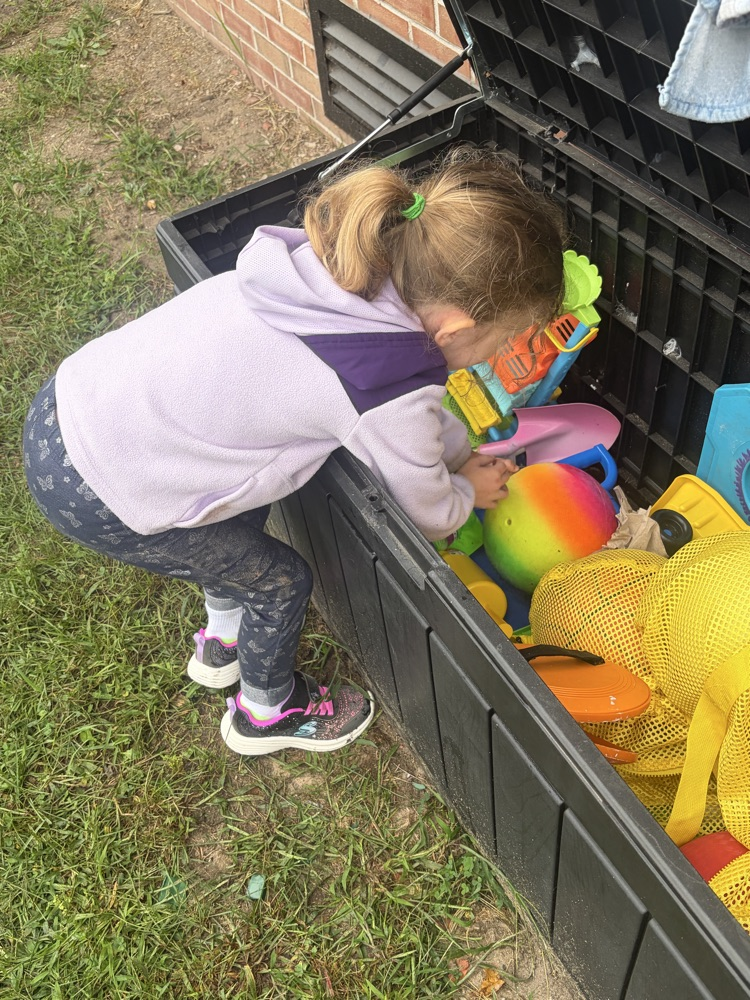 student looking in toy box