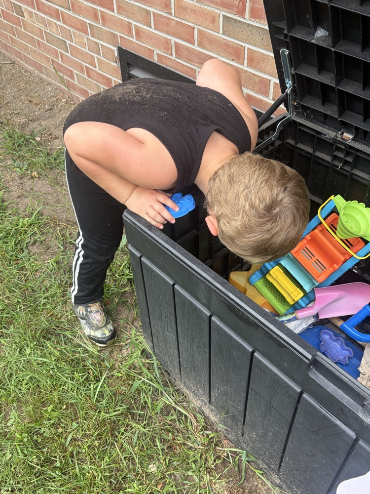 student looking in toy box