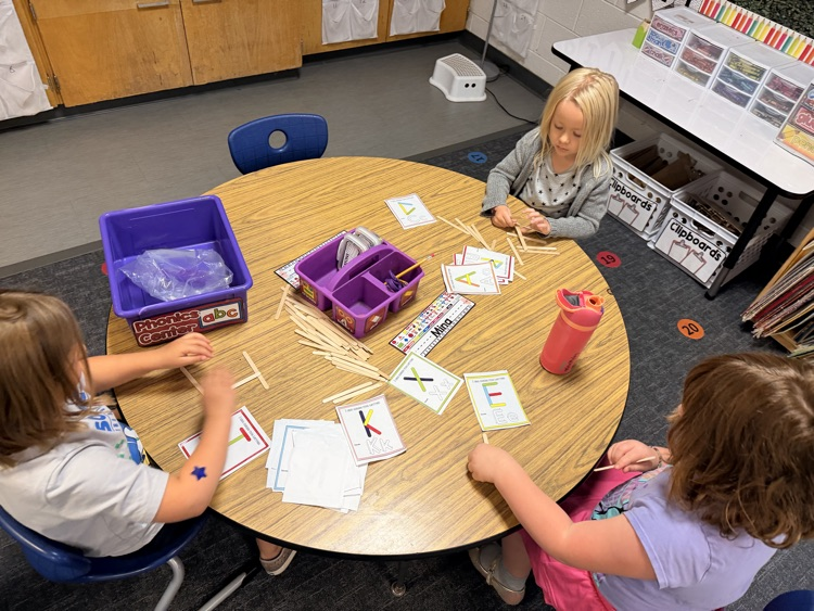 students working together with letters