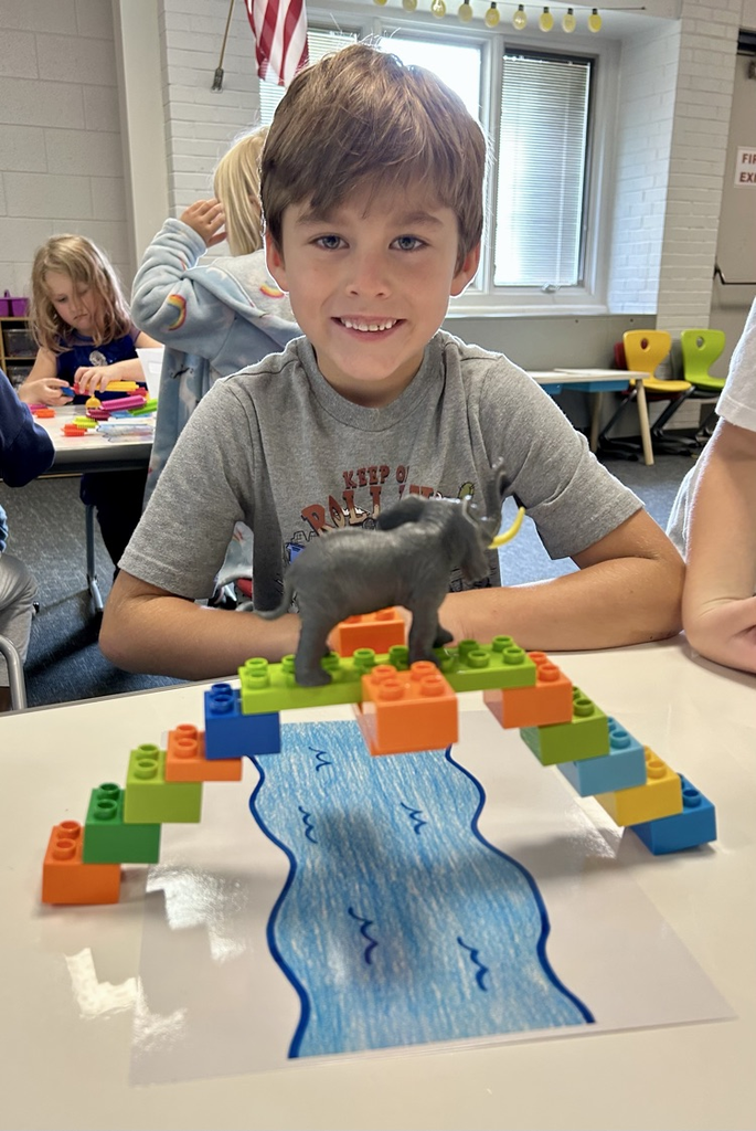 student building a bridge with toys 