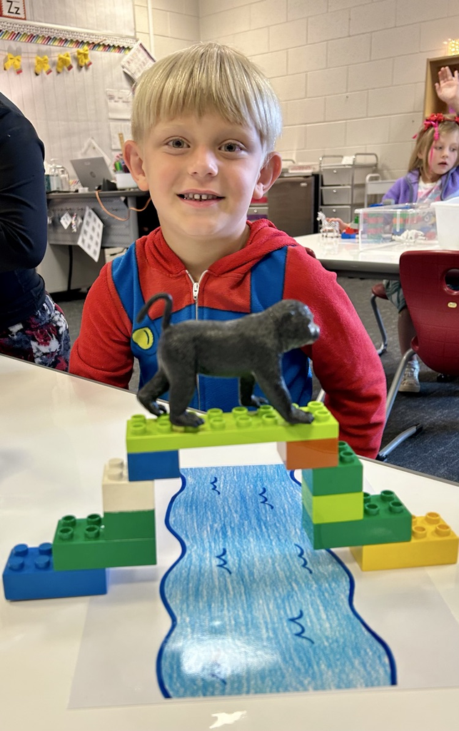 student building a bridge with toys 