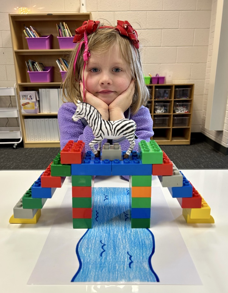 student building a bridge with toys 