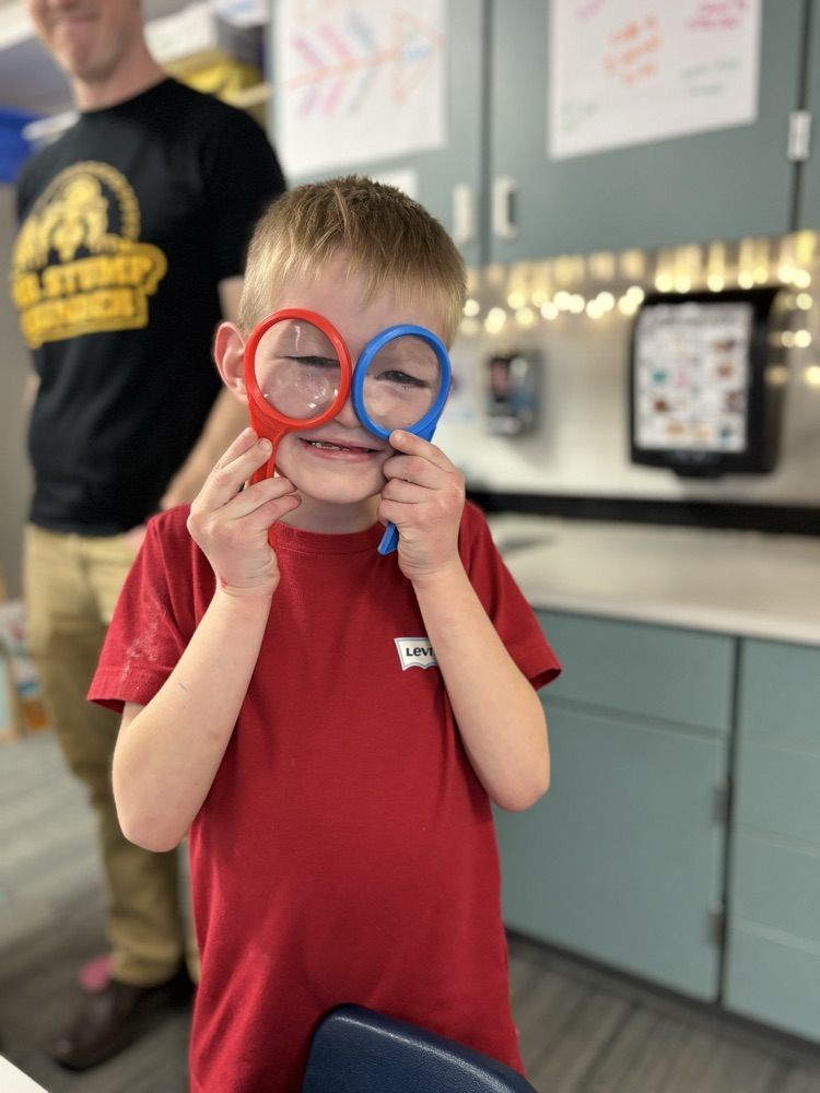 a silly student with two magnifying glasses