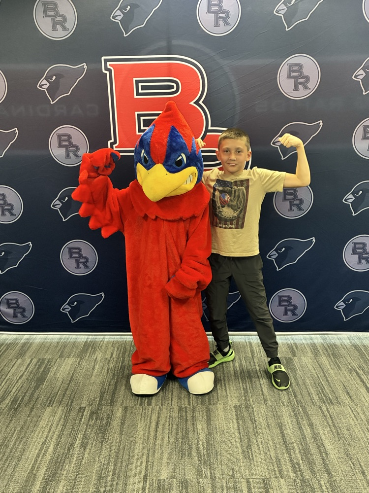 a student flexing their muscles with our BR Cardinal
