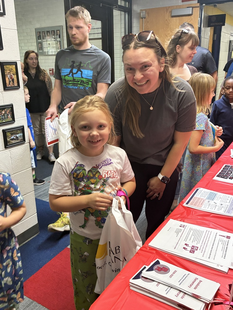 a mom and daughter at the sign in table