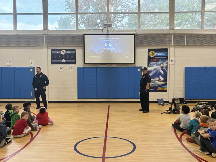 2 firefighters in the gym with students
