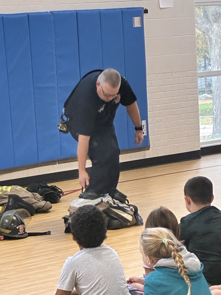 a firefighter trying on his fire suit