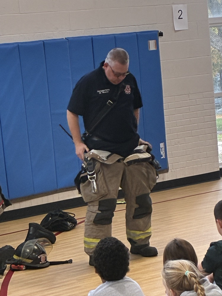 a firefighter trying on his fire suit