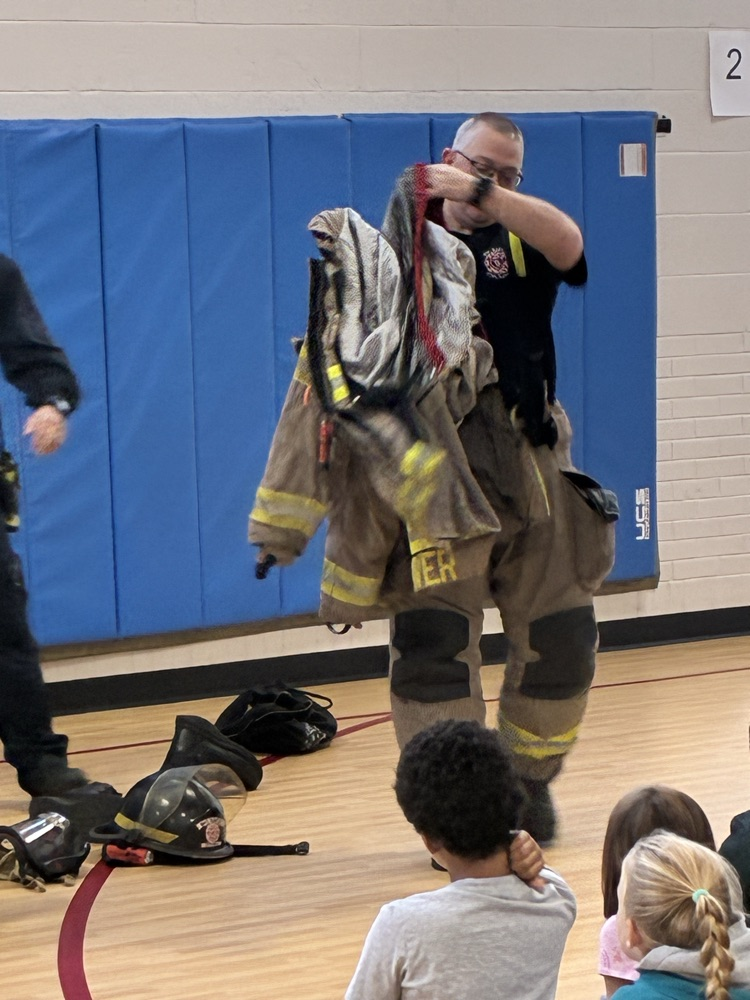 a firefighter trying on his fire suit 