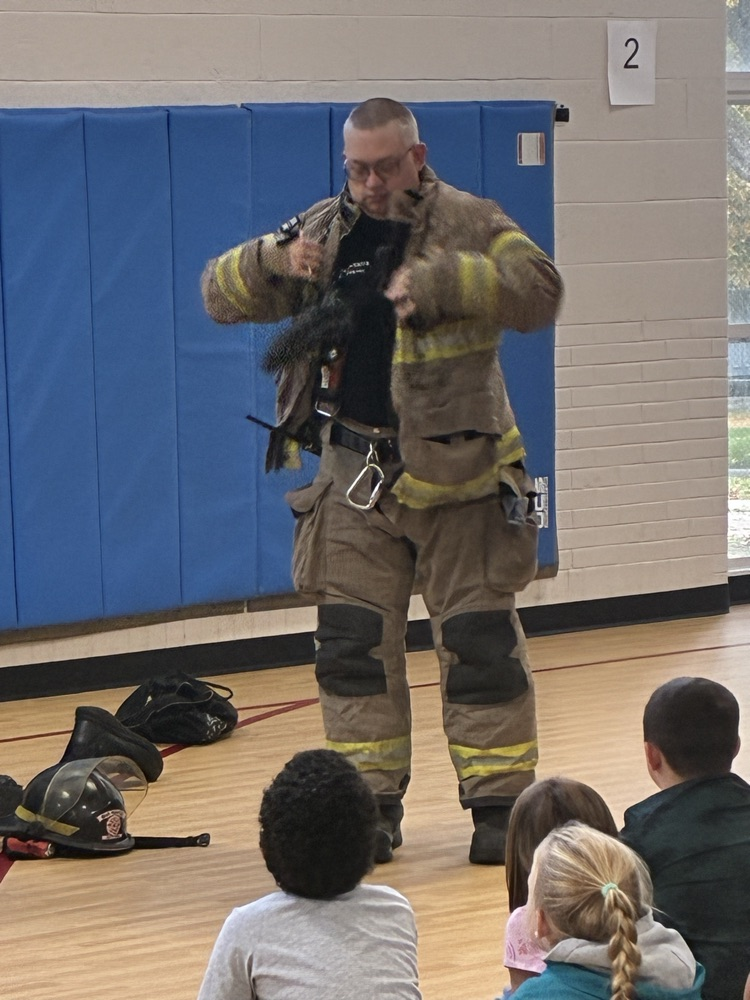 a firefighter trying on his fire suit 