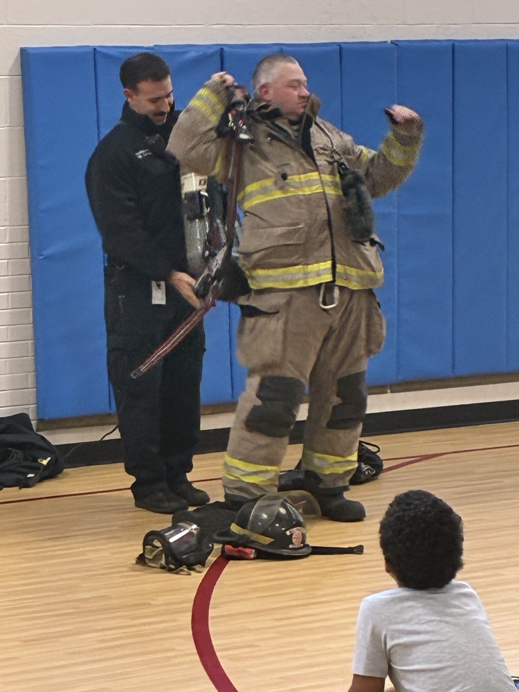 a firefighter trying on his fire suit