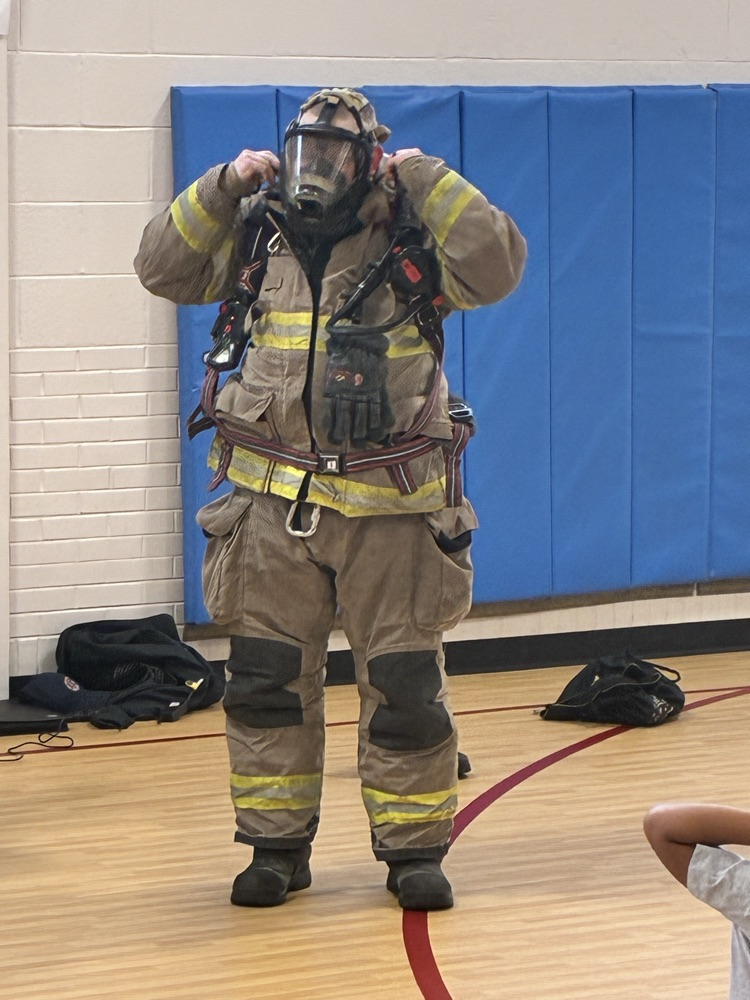 a firefighter trying on his fire suit