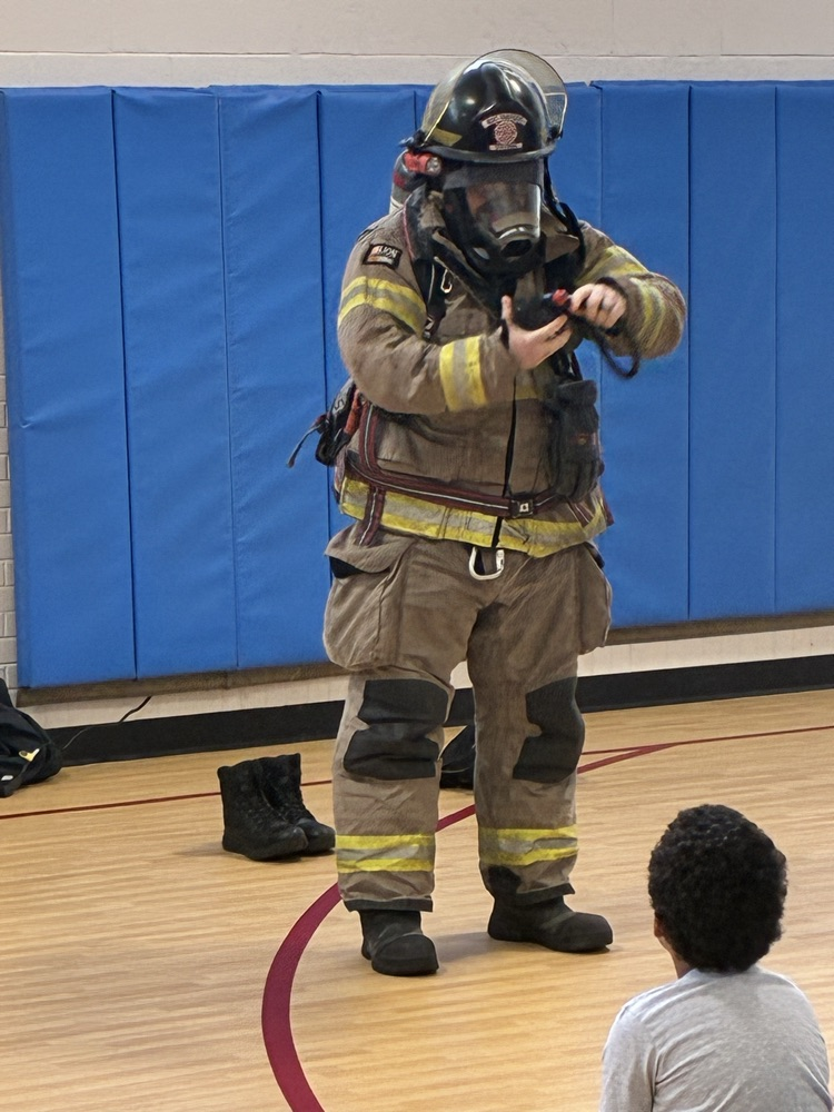 a firefighter trying on his fire suit