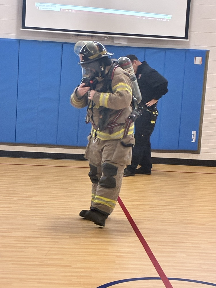 a firefighter trying on his fire suit 
