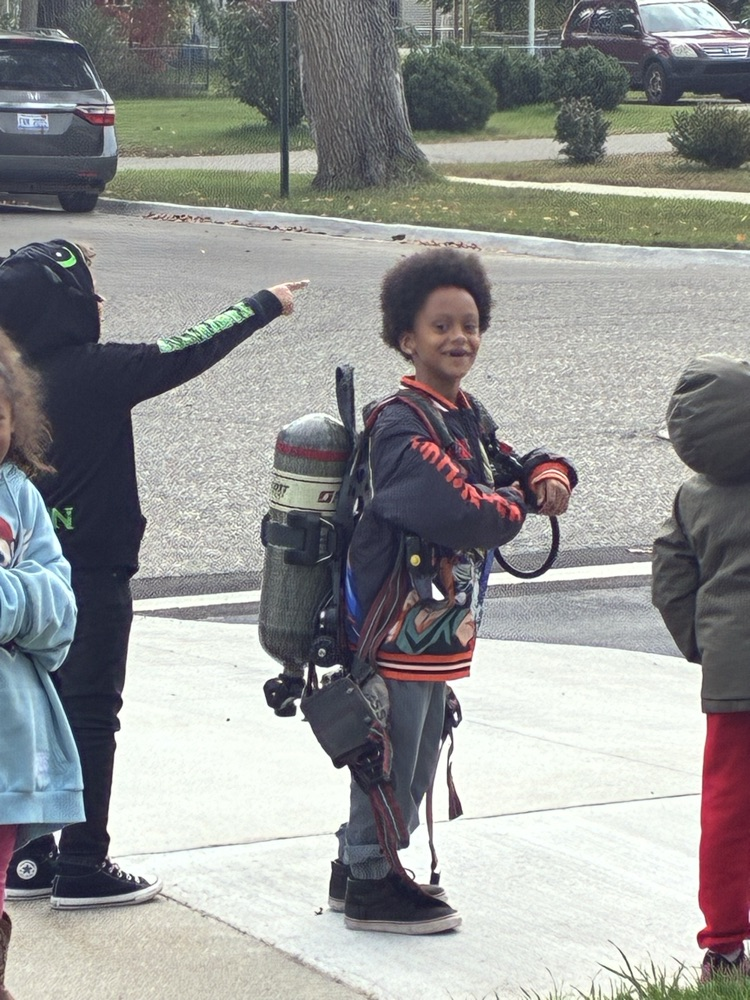 A 1st grade student tries on fire gear