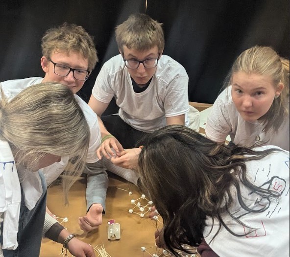 Students working on marshmallow towers for their team competition
