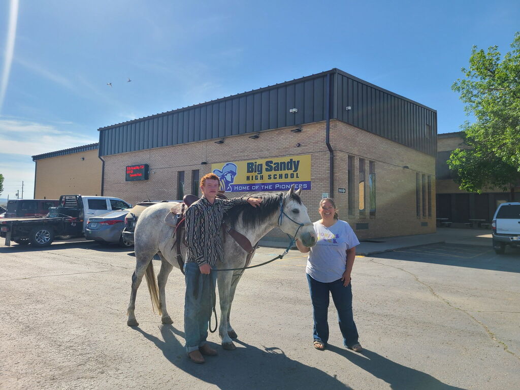 quinn and the principal with his horse on the last day of school 