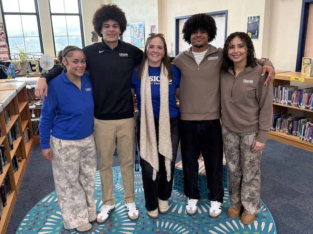 bhs visions credit union interns pose for photo in west middle library with their advisor