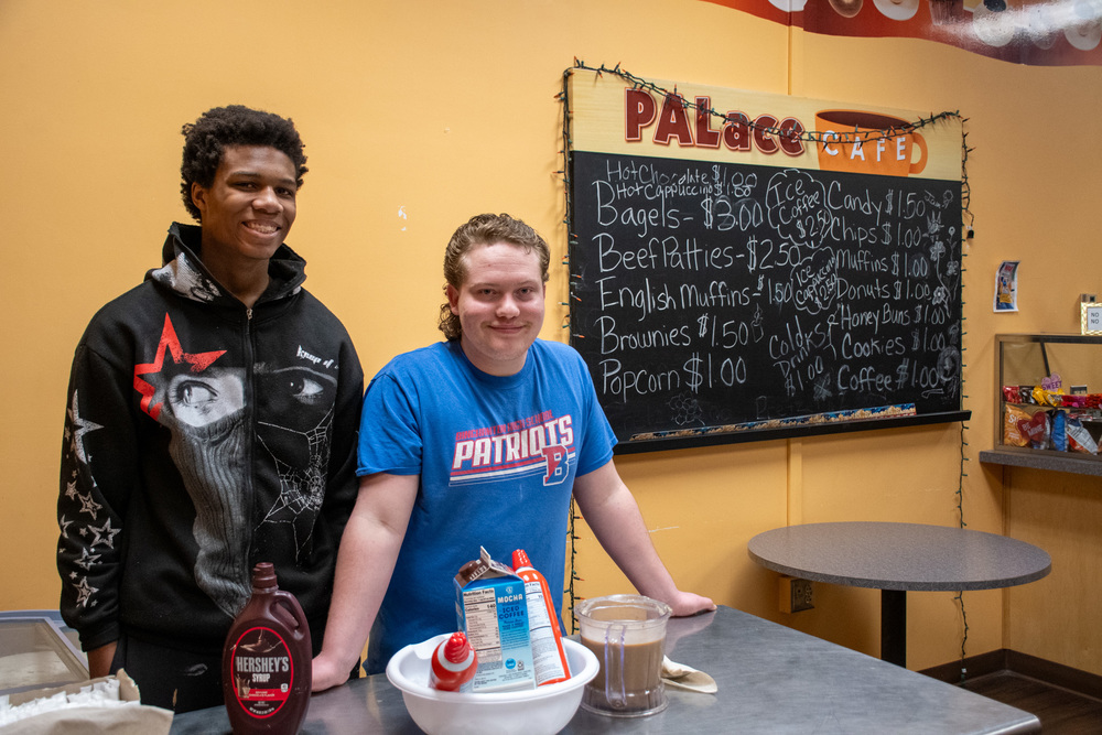 students smile for photo at iced coffee station at the PALace Cafe