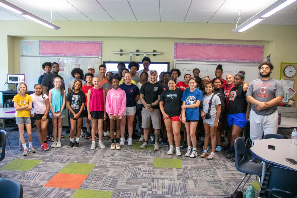 binghamton fire fighters pose for photo with students
