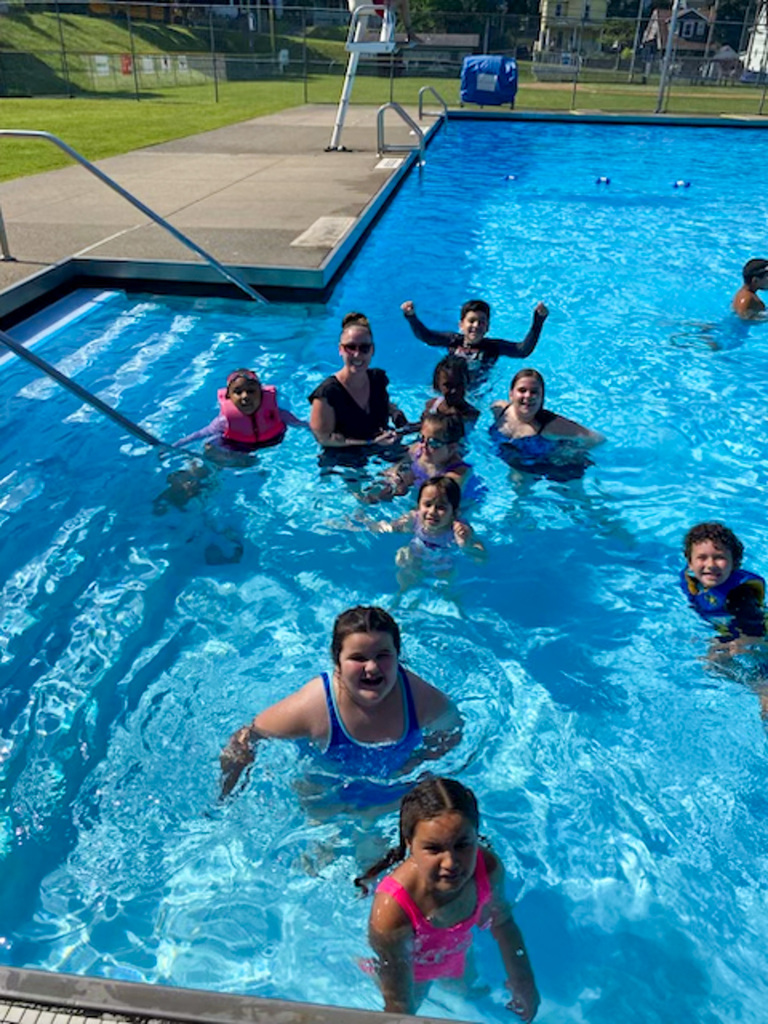 students from roosevelt's imagination adventure smile for photo while in the pool