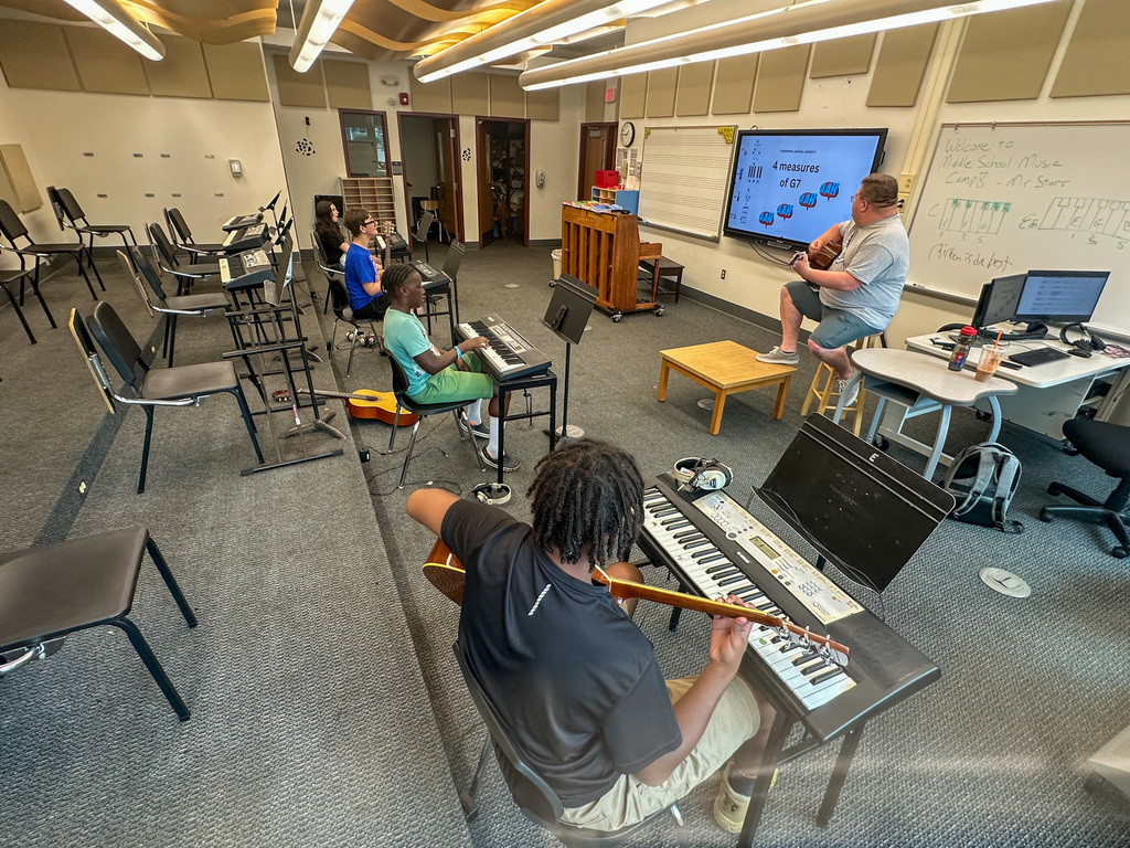 middle school students play "twist and shout" during music camp at east middle
