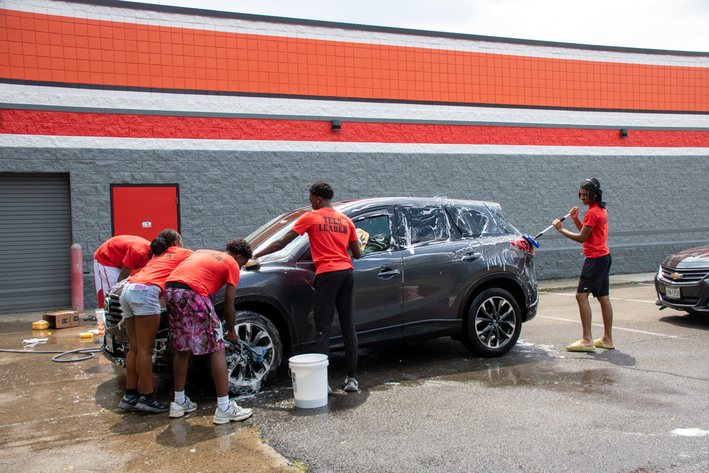 liberty partnerships students wash a car during their car wash fundraiser