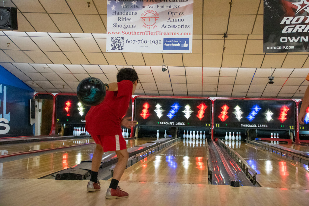 student swings arm back to throw ball at bowling camp