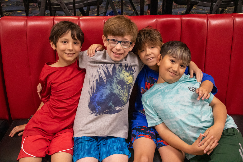 four students pose for photo during bowling camp