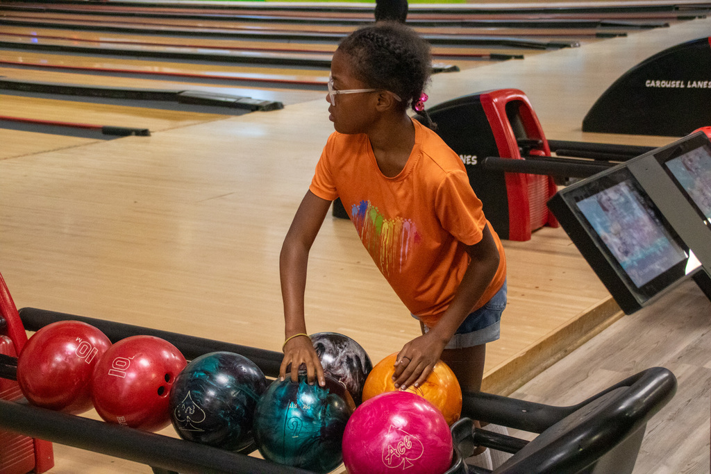 student chooses a bowling ball during bowling camp