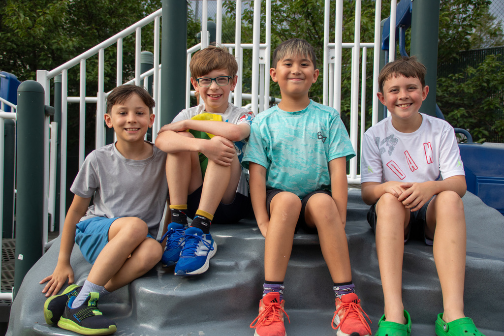 four jefferson students sitting on playground