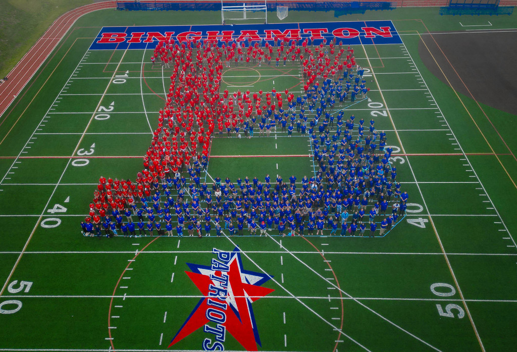aerial photo of BCSD staff standing on athletic field in the shape of the Binghamton B logo