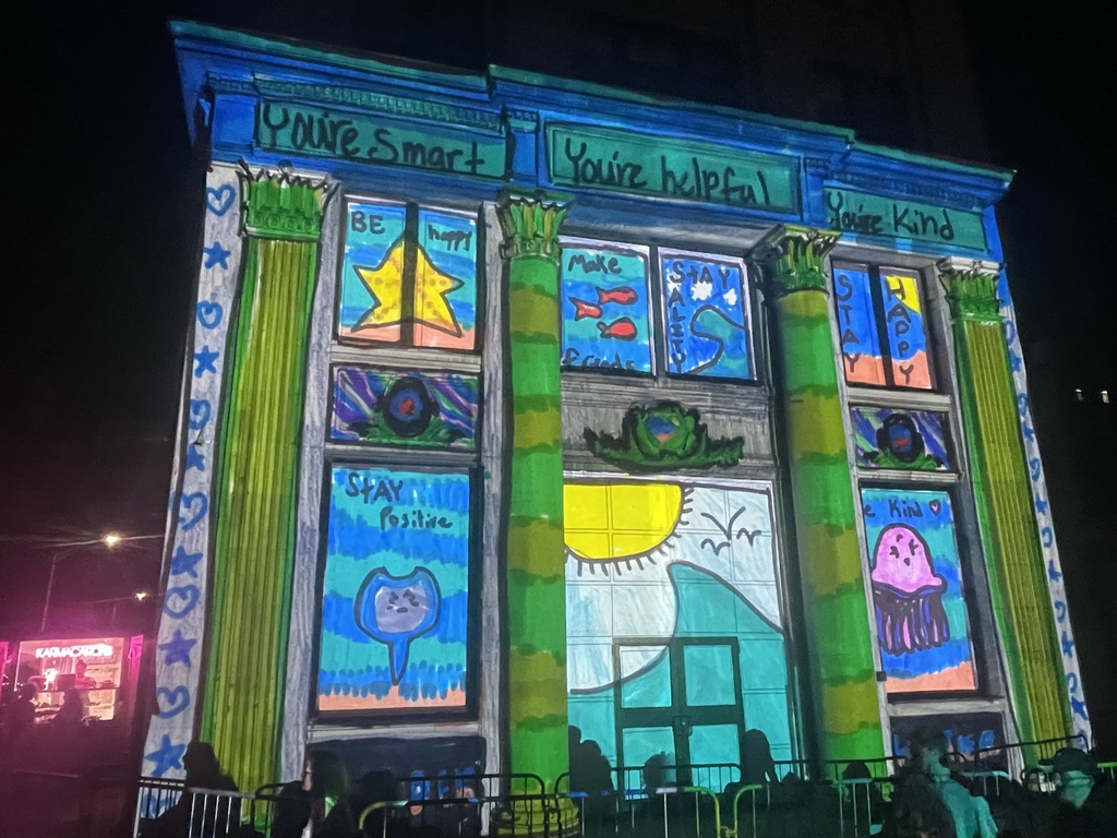 artwork by sadie walker projected onto building in downtown binghamton