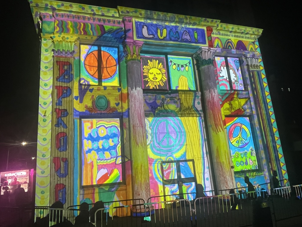 artwork by ania smeu projected onto building in downtown binghamton