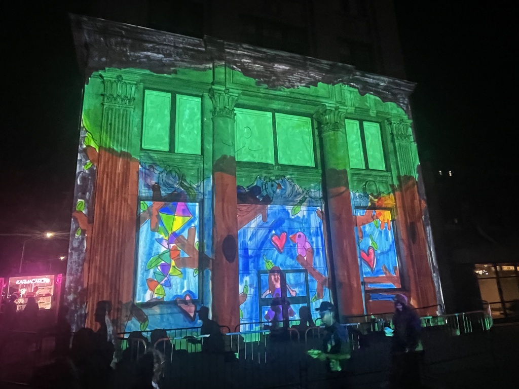artwork by avery crandell projected onto building in downtown binghamton