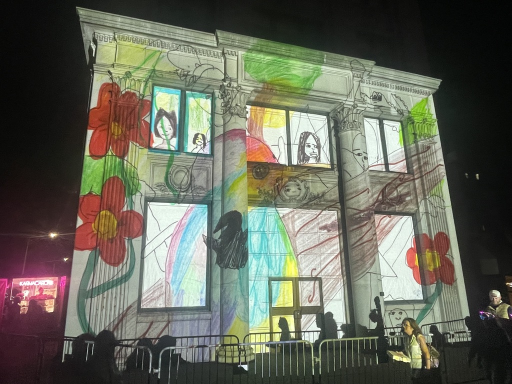 artwork by jadorae holloman projected onto building in downtown binghamton