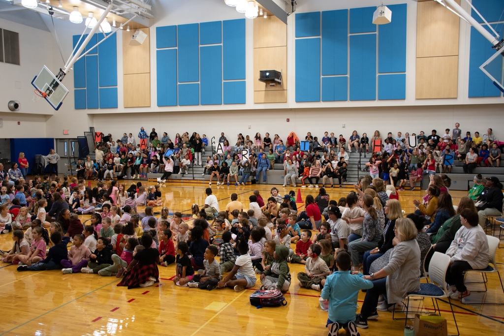 students fill macarthur gymnasium for assembly