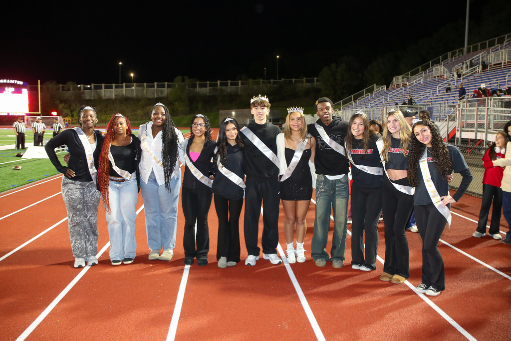 homecoming royalty poses for a photo during binghamton high school's homecoming game