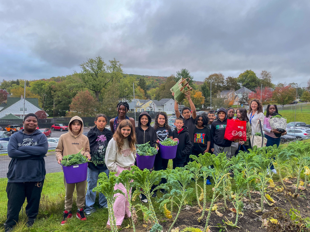 franklin students pose for photo with kale they harvested from their school garden