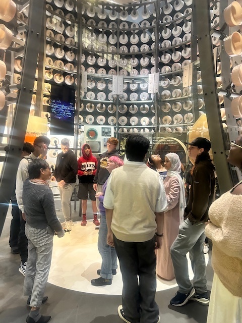 bhs students listening to tour guide during visit to corning museum of glass