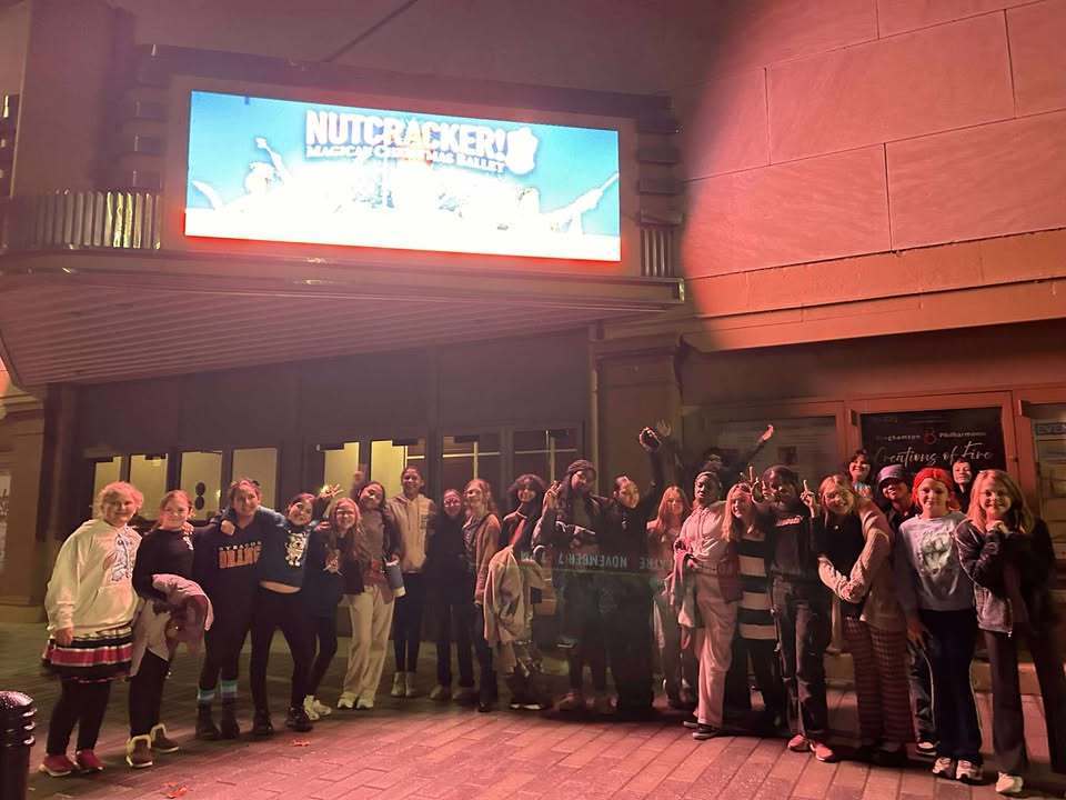 6th grade dance students pose for photo outside forum theatre