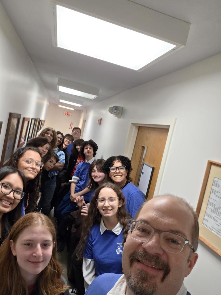bhs steel drum band members pose for photo in hallway