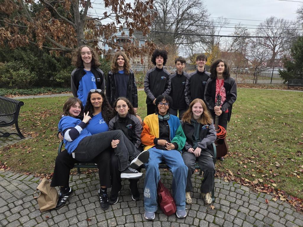 members of bhs steel drum band pose for photo oustide broome county library