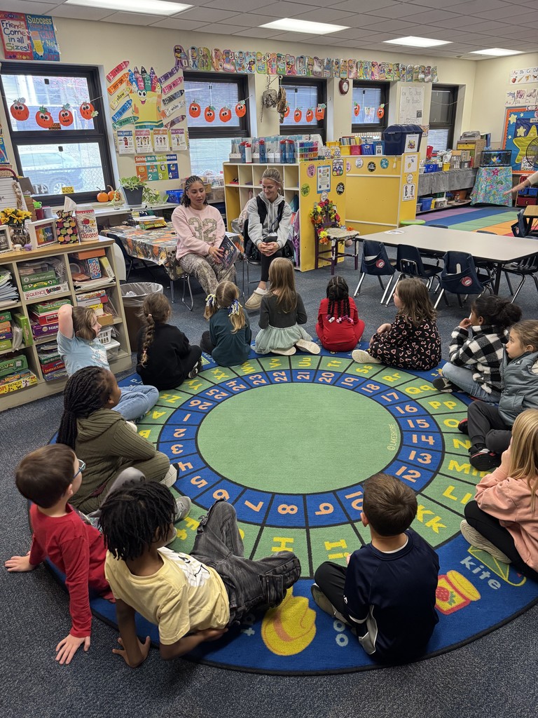 high school students read to kindergarteners at thomas jefferson