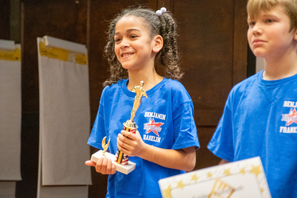 ben franklin student holding trophy