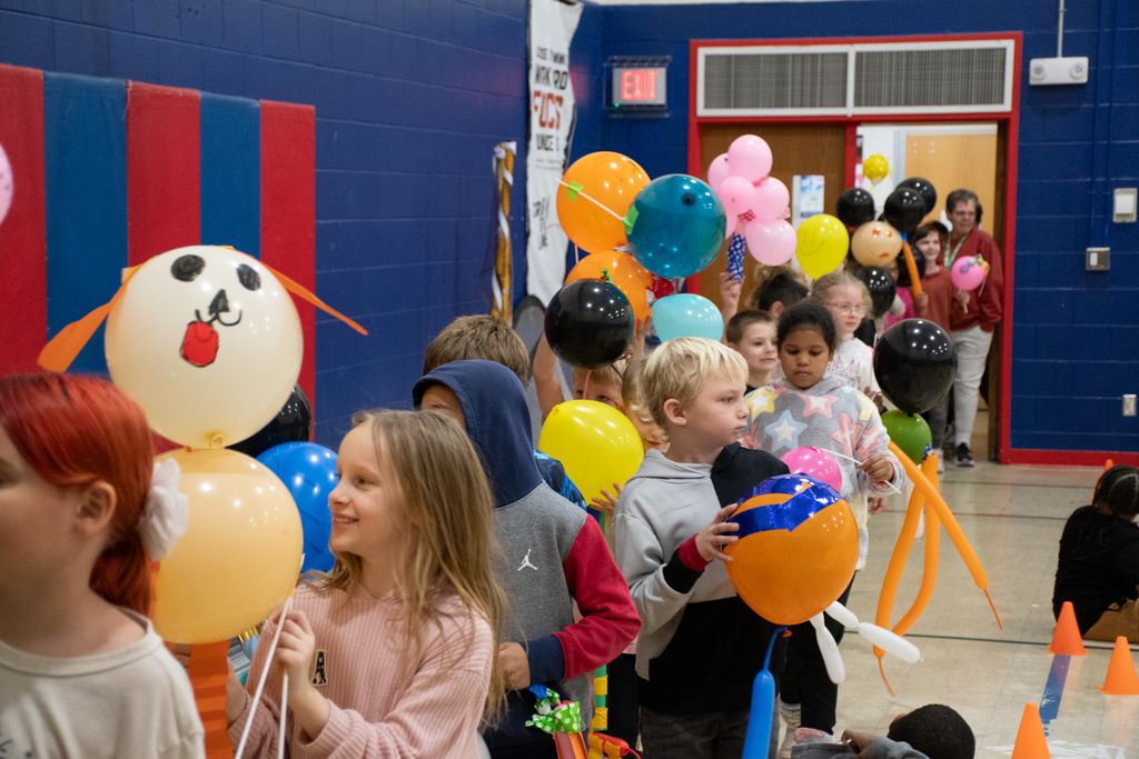mann students hold balloons during balloons over mann parade