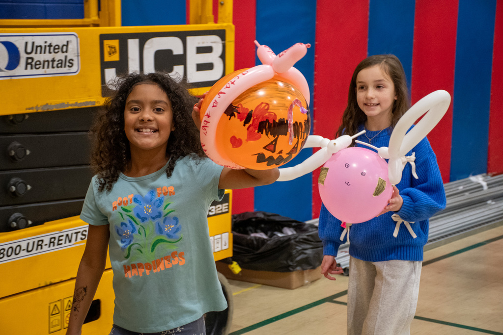 mann students hold balloons during balloons over mann parade