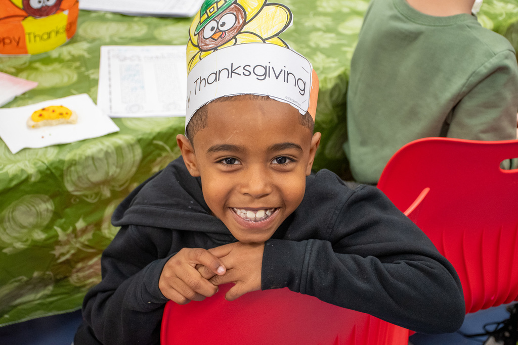 franklin student smiles for camera during second grade thanksgiving feast