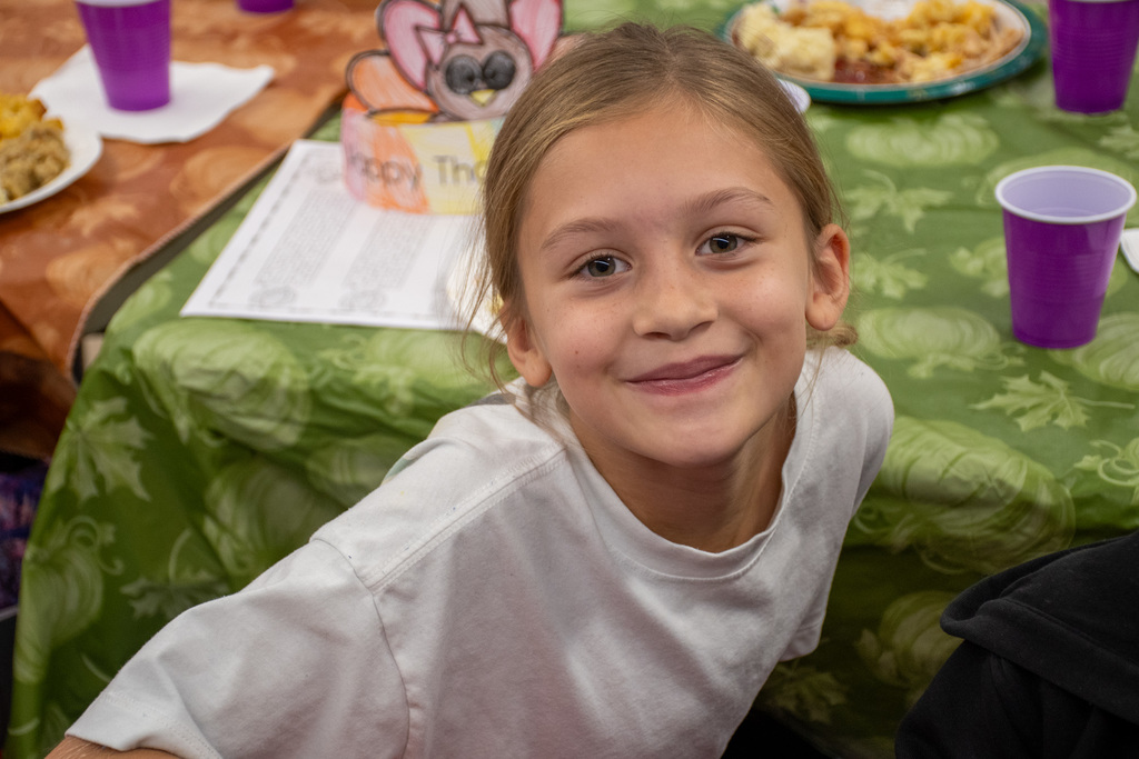 franklin student smiles for camera during second grade thanksgiving feast