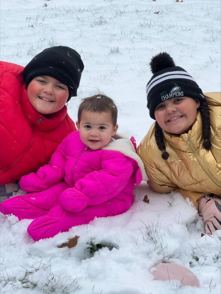 three girls pose for photo in the snow